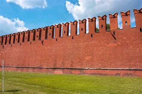 The famous Kremlin wall with dovetail crenellations. The texture of the red ancient brick ...