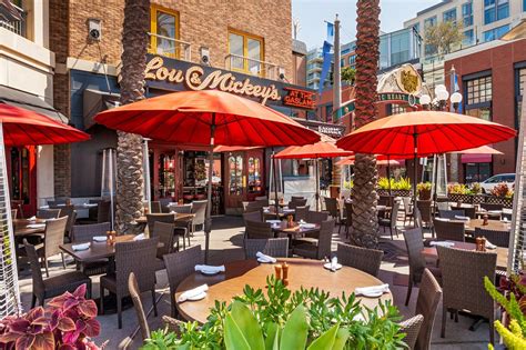 an outdoor dining area with tables and umbrellas