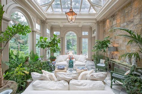 a living room filled with lots of furniture and plants on top of a white couch