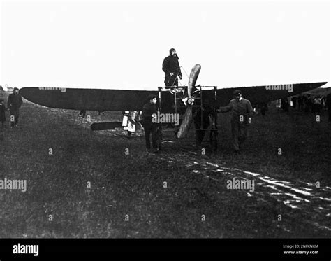 Pilot Louis Bleriot stands in the cockpit of his plane while mechanics give the plane a final ...