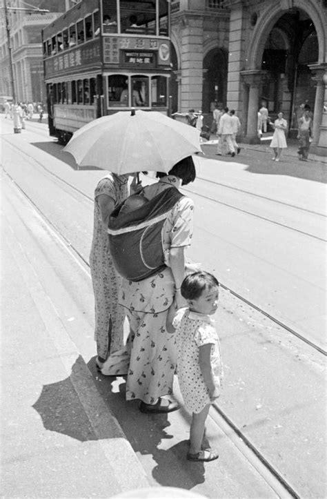 Hong Kong, women with children crossing street with trolley tracks | Hong kong, Mei tai, Kong