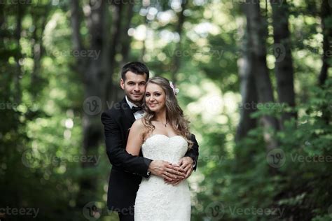 Beautiful wedding couple posing in forest 11434394 Stock Photo at Vecteezy