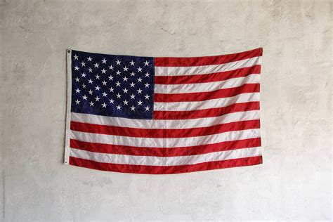 USA flag hanging on wall. Fourth of July by Danil Nevsky - Stocksy United