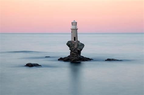 Premium Photo | Tourlitis lighthouse at sunset andros greece