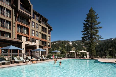 A building overlooks an outdoor pool lined with deck chairs | Tahoe rentals, Lake tahoe resorts ...