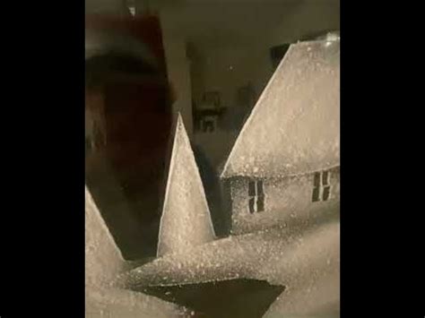 the snow is falling on top of the houses