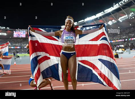 Amber Anning celebrating her medal with her country's flag in the 4x400 meter relay at the World ...