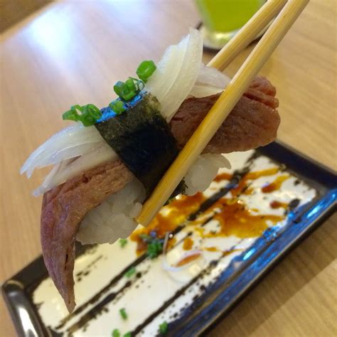 a sushi dish with chopsticks on top of it