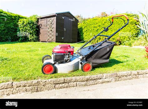 lawnmower grass cutting machine grass cutter gardening gardeners tool UK England GB Stock Photo ...