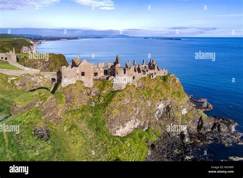 Ruins of medieval Dunluce Castle, cliffs, bays and peninsulas. Northern ...