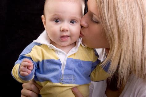 Young Beautiful Mom Kissing Baby On Cheek Stock Photo - Image of ...