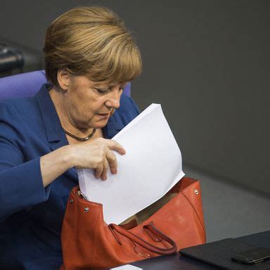 Angela Merkel Loves Rummaging Through Her Enormous Handbag