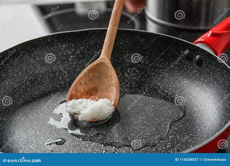 Wooden Spoon with Coconut Oil in Frying Pan Stock Image - Image of ...