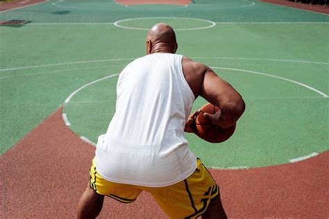 "Unrecognisable Black Man With A Basketball" by Stocksy Contributor "Mak" - Stocksy