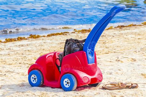 Red and blue toy car on the beach in Playa del Carmen Mexico. 18853760 Stock Photo at Vecteezy