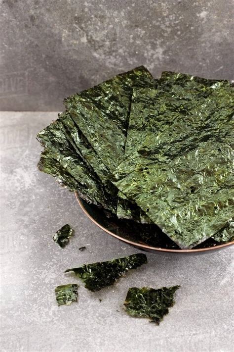 A bowl of seaweed chips - Stock Photo - Dissolve