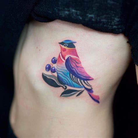 Colorful bird tattoo on the rib cage - Tattoogrid.net