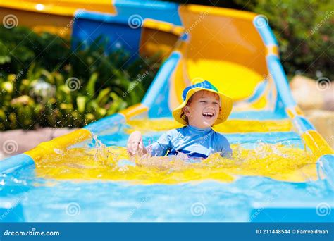 Kids on Water Slide in Aqua Park. Summer Vacation Stock Photo - Image of dump, palm: 211448544