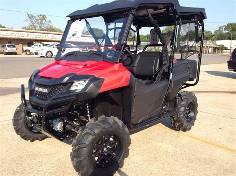 a red and black utility vehicle parked in a parking lot