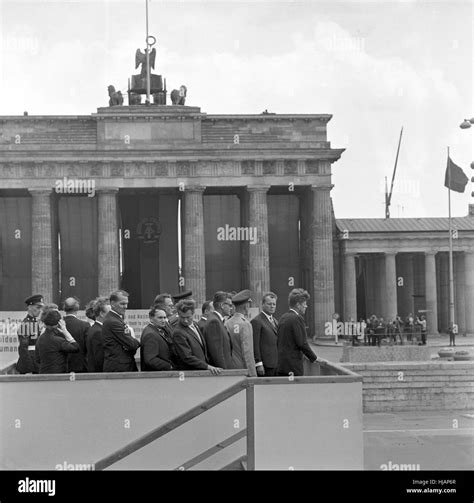 US president John F. Kennedy (r) at a view point at the Berlin wall near the Brandenburg Gate on ...