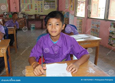 Asian student is writing. editorial stock photo. Image of school ...