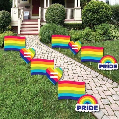 pride rainbow flag lawn decorations in front of a house