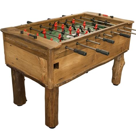 an old wooden foosball table with red and black pins on it's legs