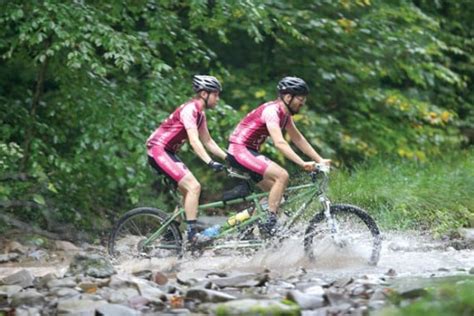 Two friends brave the elements in the SM 100 aboard a tandem bicycle.