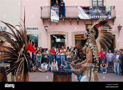 An AZTEC DANCE TROUPE performs in traditional feathered COSTUMES at the CERVANTINO FESTIVAL ...