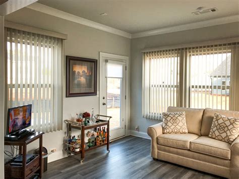 Stylish Vertical Blinds In A Warm Living Room Featuring Beige Accents ...