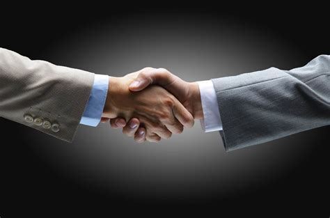 Handshake - Hand holding on black background | insurethebox