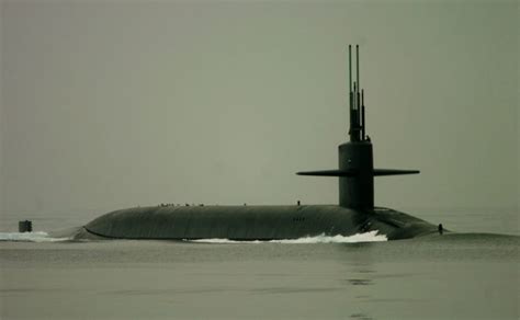 Ohio-class guided-missile submarine USS Georgia, accompanied by two ...