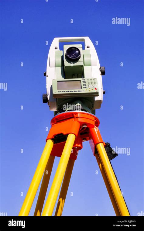 Total station with blue sky in the background. Survey Instrument geodetic device, total station ...