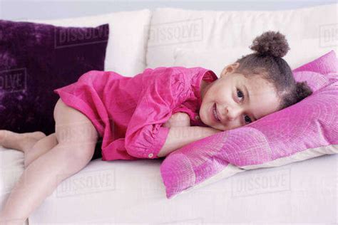 Little girl lying on couch - Stock Photo - Dissolve