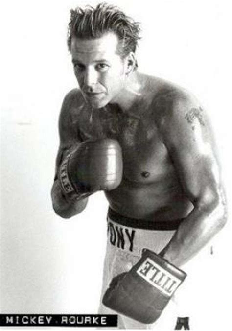 a black and white photo of a man wearing boxing gloves