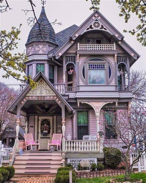 an old victorian house with pink and purple accents