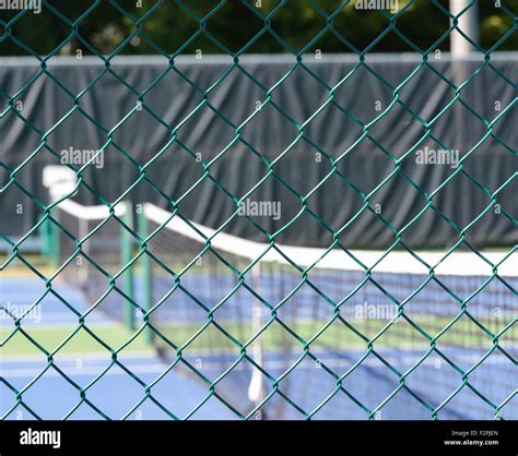 Tennis court through screen Stock Photo - Alamy