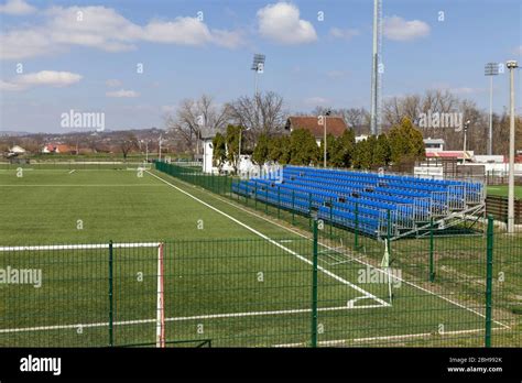 outdoor football stadium, with green grass and small blue stands Stock ...