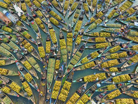 Aerial view of floating market of seasonal fruits on the boats in ...