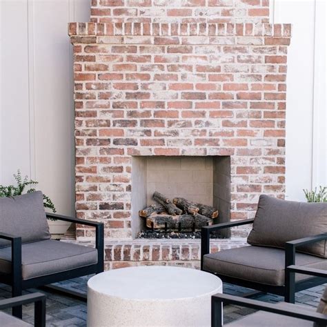 We’ve always loved a good red brick front patio fireplace! Combine it with some antique white ...