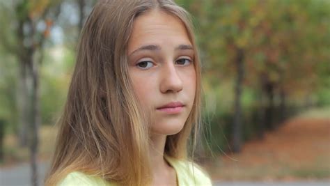 Sad face teenage girl looking at camera outdoors,… - Royalty Free Video