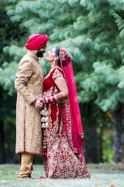 Indian Couple in Traditional Red and Gold Wedding Outfits