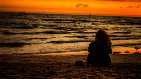 Girl Is Sitting On Beach Sand Watching Ocean Waves During Sunset HD Beach Wallpapers | HD ...