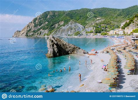 Chairs and Umbrellas Fill the Spiaggia Di Fegina Beach , the Wide Sandy Beach Village of ...