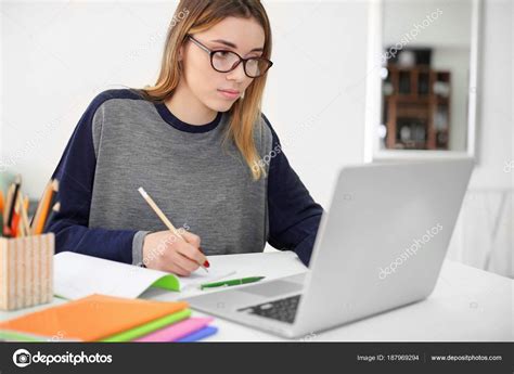 Pretty student with laptop studying at table indoors Stock Photo by ...