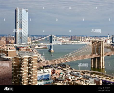 Rooftop view of the Brooklyn and Manhattan bridges, the FDR Parkway, and the East River, Lower ...