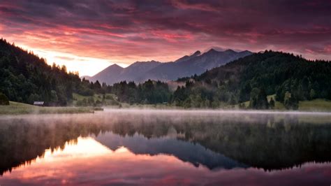 Landscape Of Green Trees Covered Mountain During Sunset With Reflection ...