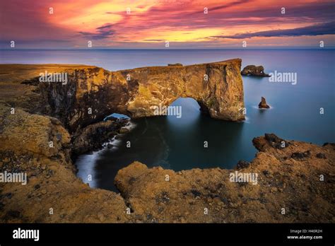 Sunset on Dyrhólaey Arch in Iceland Stock Photo - Alamy