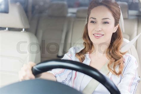 portrait of smiling woman driving car alone | Stock image | Colourbox