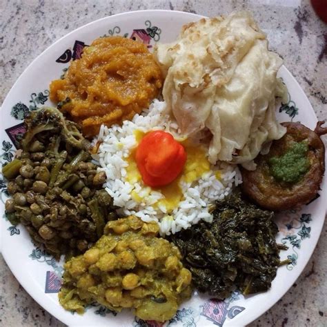 a white plate topped with different types of food on top of a marble countertop